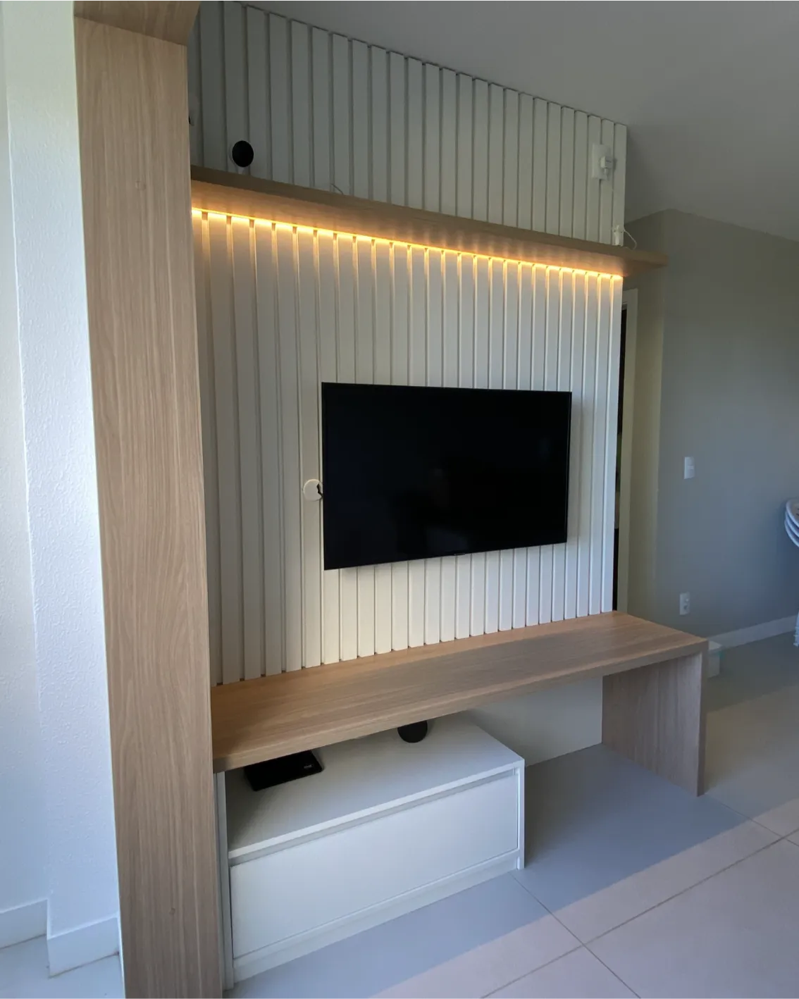 Sala planejada moderna com rack e painel funcional